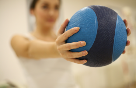 Woman holding medicine ball